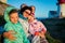 Portrait of big family, sitting on windy top of rock with lighthouse.