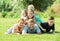 Portrait of big vigorous family lying together on green lawn out