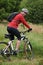 Portrait, bike and man cycling in countryside for adventure, discovery or off road sports hobby. Fitness, health and