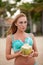 Portrait of bikini young woman posing with green coconut on the beach near palm trees. Vietnam.