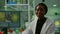 Portrait of biologist researcher woman in white coat looking into camera