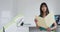 Portrait of biracial female patient holding documents at modern dental clinic