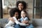 Portrait of biracial mom relax with multiethnic daughters