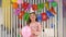 Portrait of a birthday girl with a festive cap with balloons at a birthday party