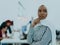 Portrait of a black african-american female muslim standing in a modern business office while wearing a hijab.