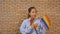 Portrait of Black African American woman celebrating with a LGBT flag gay or lesbian flag or rainbow flag. Pride symbol. People