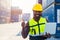 Portrait Black African staff worker happy smile working in cargo crane shipping logistic port with laptop computer