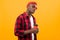 Portrait of a black american man dressed stylishly holding a drink glass on a coffee break yellow background