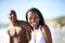 Portrait of black couple on beach, relax and smile on holiday with swimwear, sunshine and tropical travel. Sea, happy