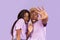 Portrait of black couple with scared or shocked faces on lilac background