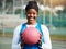 Portrait, black girl with netball and sports with smile, fitness and training for game outdoor, happy teen and ready