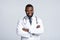 Portrait of black male doctor with stethoscope on white background