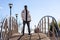 Portrait of black man with sunglasses posing in the middle of a bridge, horizontal urban background