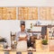Portrait, black man and waiter with arms crossed in cafe with pride for career or job. Barista, smile and confidence of