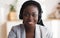 Portrait of black smiling female call center operator in headset