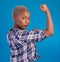 Portrait, black woman and flex arms on blue background, studio and backdrop of freedom, empowerment or pride. Female