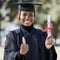 Portrait, black woman and thumbs up for graduation, education and success with degree. African American female, hand or
