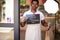 Portrait of black worker of cafe holding sign