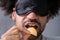 Portrait Of Blindfolded Man Tasting Food