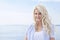 Portrait of blond beautiful young woman on sailing boat.