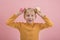 Portrait of blond boy in bright clothes with cupcakes in his hands on pink background. Childrens party with sweets