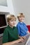 Portrait of blond brothers using laptop