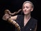 Portrait of blond woman holding snake