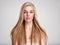 Portrait of a blonde beautiful woman with a long straight light hair. Portrait of a beautiful woman with a coral color makeup.