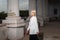 Portrait of a blonde model, fashion girl in a white jacket, posing, against the background of vintage columns. beauty and fashion