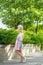 Portrait of a blonde in pink attire in a park outdoors.