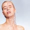 Portrait of blonde woman with drops of water on her face.  Photo of  young woman with clean skin and splash of water.Spa treatment