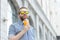 Portrait of a blurred stylish young hipster male with beard and mustache holding fresh orange juice in his hands