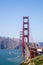 Portrait of boat traveling under the famous golden gate bridge