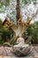 Portrait, Bodhisattva with snakes statue under Ficus Religiosa tree on Ko Samui Island, Thailand