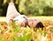 Portrait, book and woman relax in park with novel in nature learning for education as student outdoor on campus