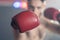 Portrait of Boxer wear boxing gloves, look at camera in fitness gym. Active Caucasian attractive sportsman fighter athlete workout