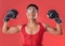 Portrait, boxing and strong gay man with motivation isolated on a red background in a studio. Fight, fitness and lgbt