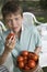 Portrait Of Boy With Bowl Of Tomatoes