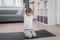 Portrait of boy child exercising with dumbbells at home. A child who strengthens the muscles of the arms.