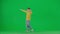 Portrait of boy on chroma key green screen. School boy kid in casual clothing dancing modern trend dance, cool