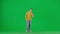 Portrait of boy on chroma key green screen. School boy kid in casual clothing taking selfie on smartphone, cool pose