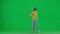 Portrait of boy on chroma key green screen. School boy kid in casual clothing in virtual reality glasses plays game