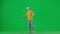 Portrait of boy on chroma key green screen. School boy kid in casual clothing in virtual reality glasses standing and