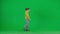 Portrait of boy on chroma key green screen. School boy kid in casual clothing in virtual reality glasses walking and