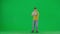Portrait of boy on chroma key green screen. School boy kid in casual holding laptop, waiting for results, happy