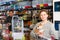 Portrait of a boy with dog in petshop, man on background