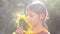 Portrait of a boy with a flower sunflower. Caucasian teenager with large flower sunflower.