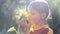 Portrait of a boy with a flower sunflower. Caucasian teenager with large flower sunflower.