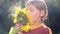 Portrait of a boy with a flower sunflower. Caucasian teenager with large flower sunflower.