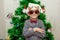 Portrait of a boy with funny glasses and christmas toys decorating cristmas tree and have fun